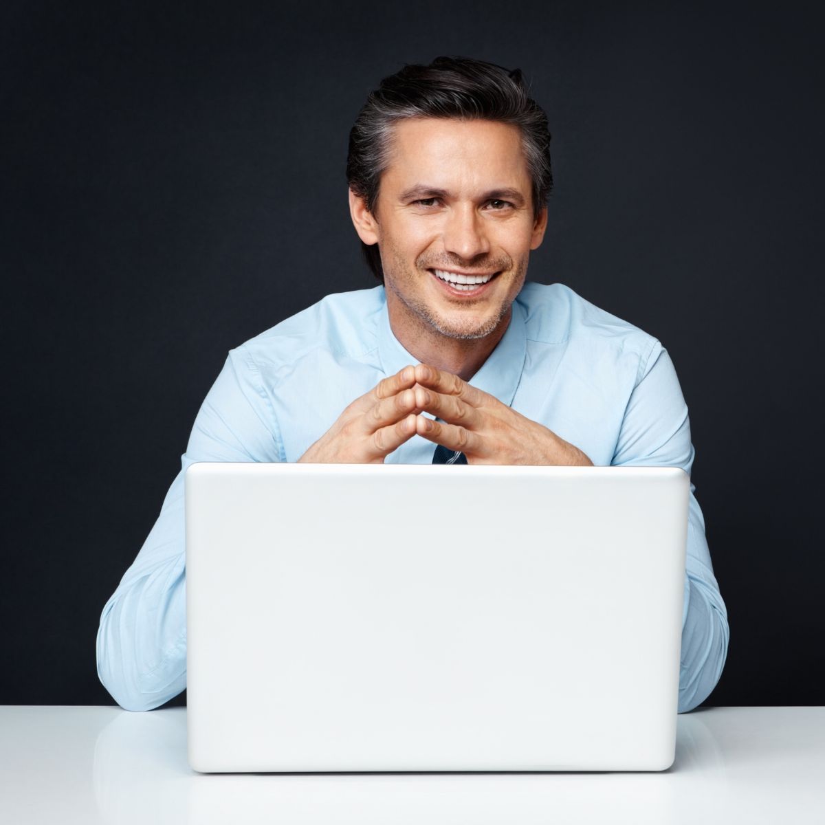 Smiling professional on laptop